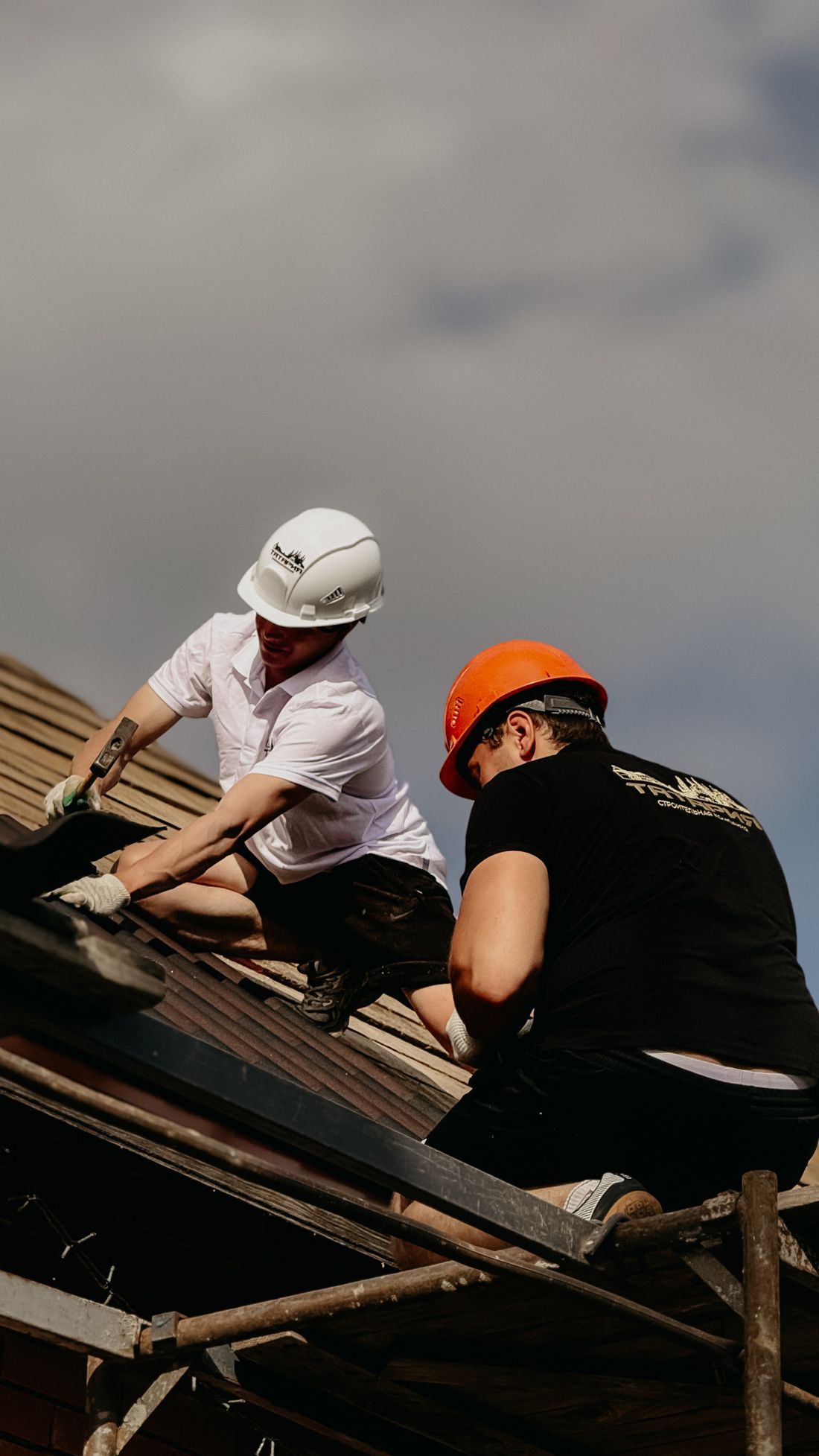 Illustrative photograph of roofers fitting a roof covering